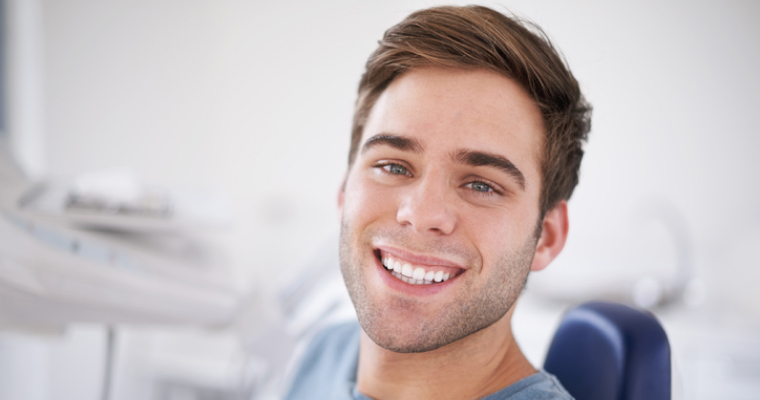 Young man smiling in a dentist's chair